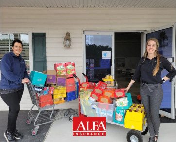 Two Alfa Agency ladies on the office porch with donated family items
